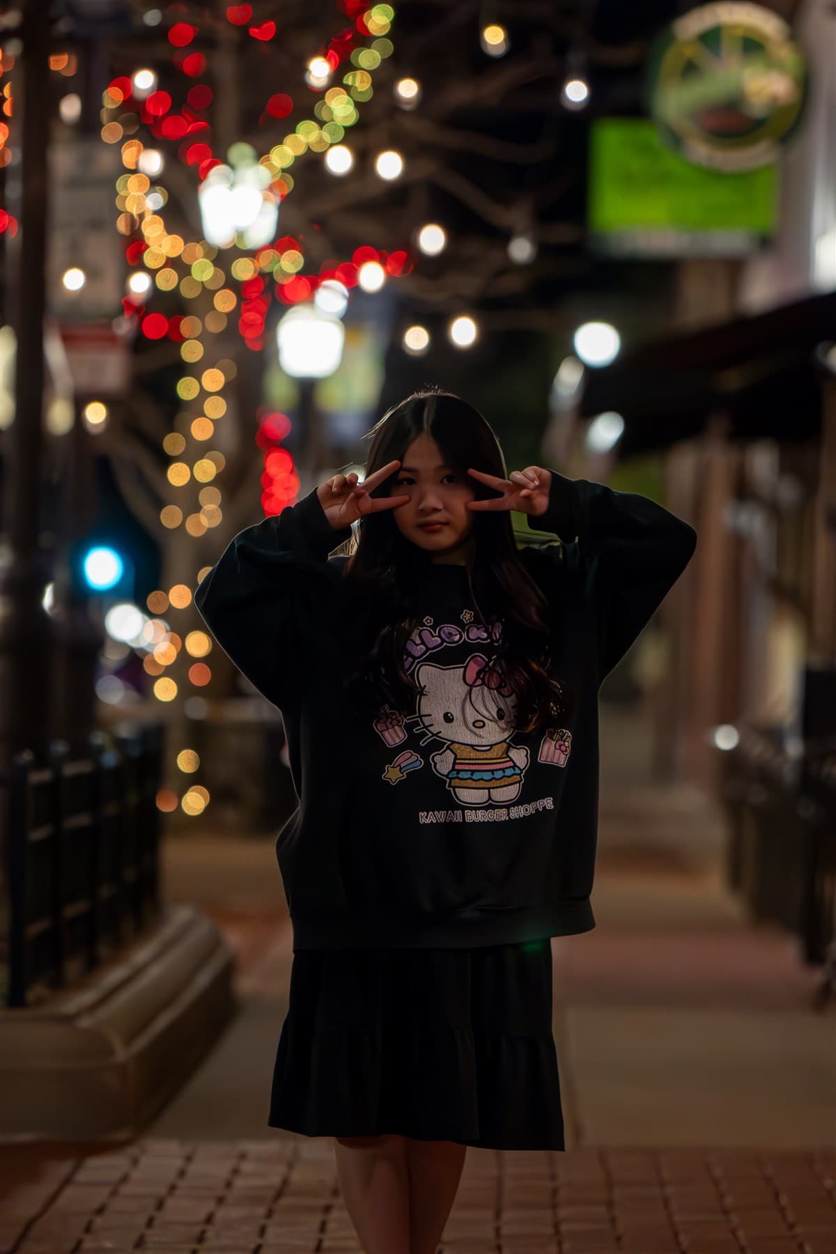 Portrait at night surrounded by colorful city lights.